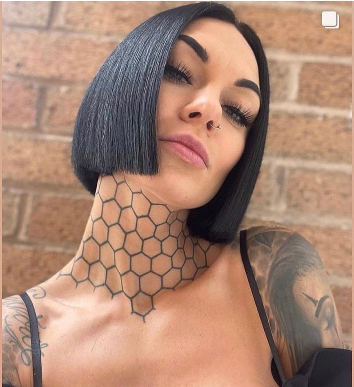 A client wearing a sharp one-length bob