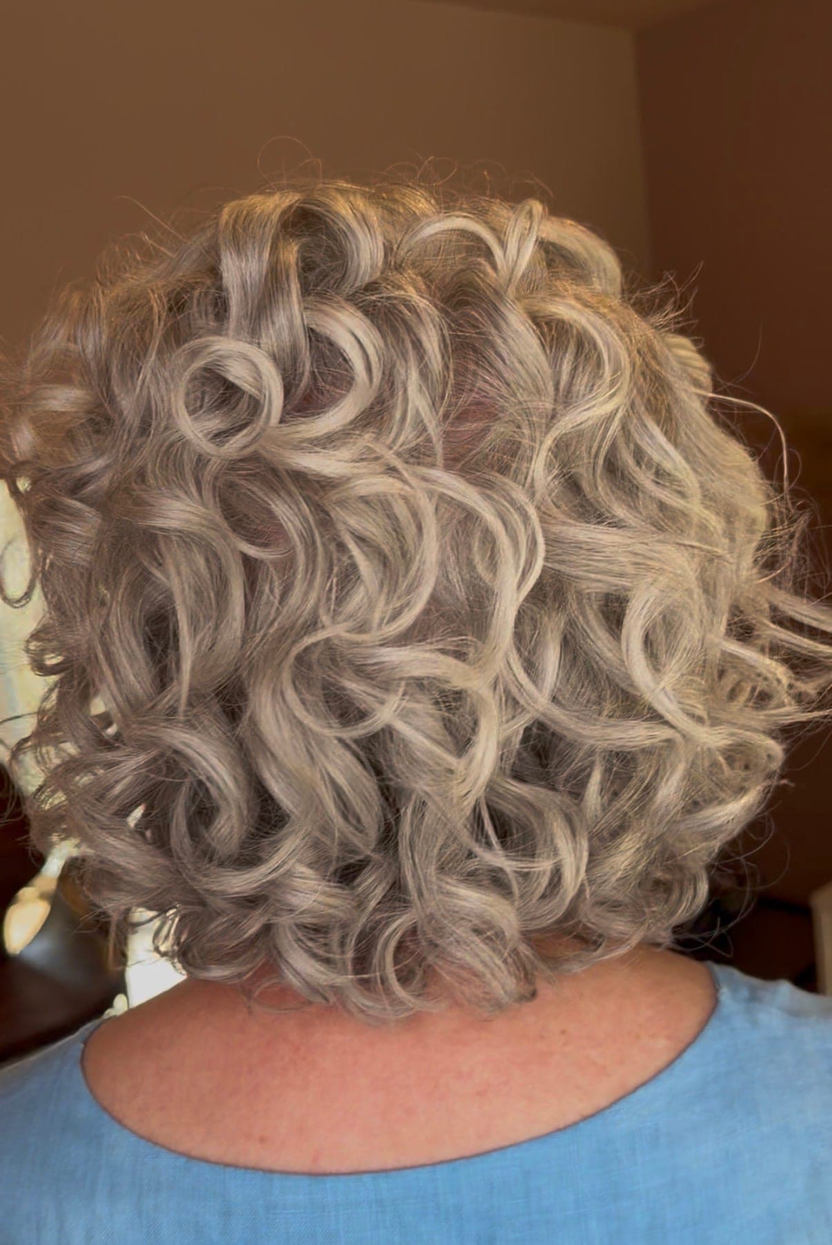 A silver curly bob, shaped and full of movement