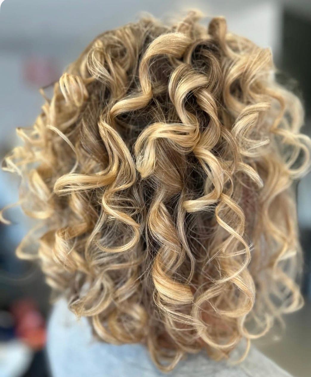 Styled blonde ringlets in the salon